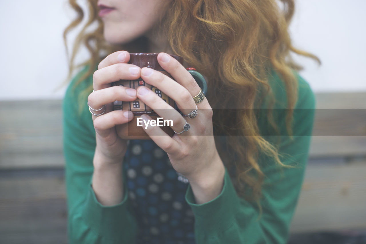 Close-up of young woman with coffee