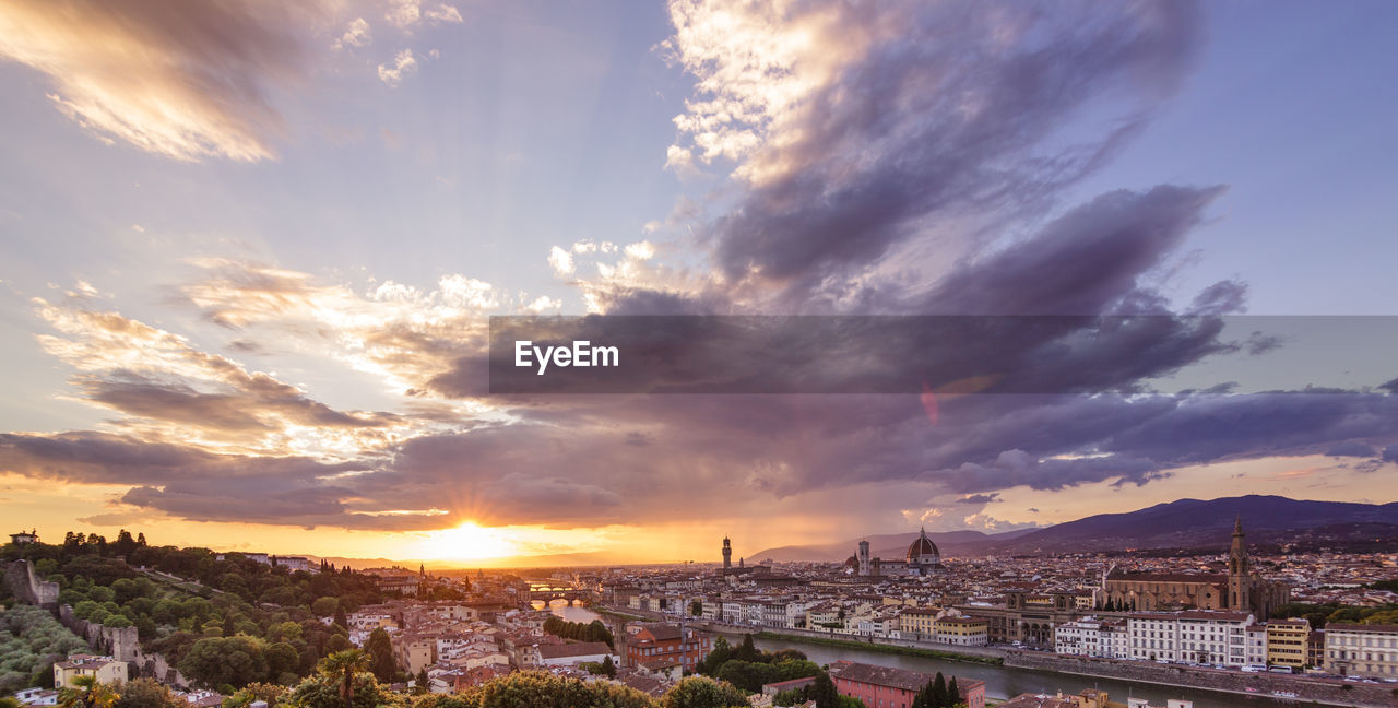 View of cityscape against cloudy sky