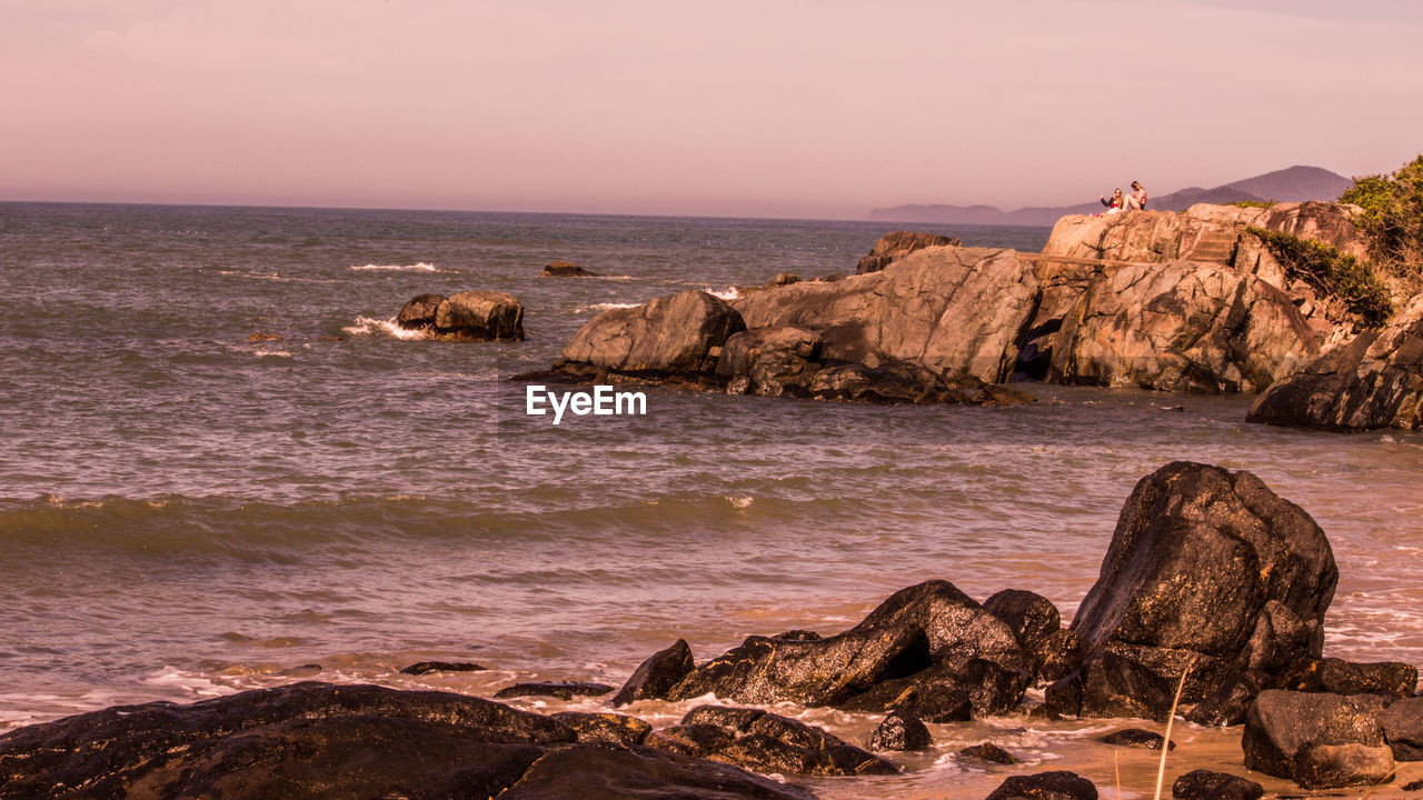 Scenic view of sea against clear sky at sunset