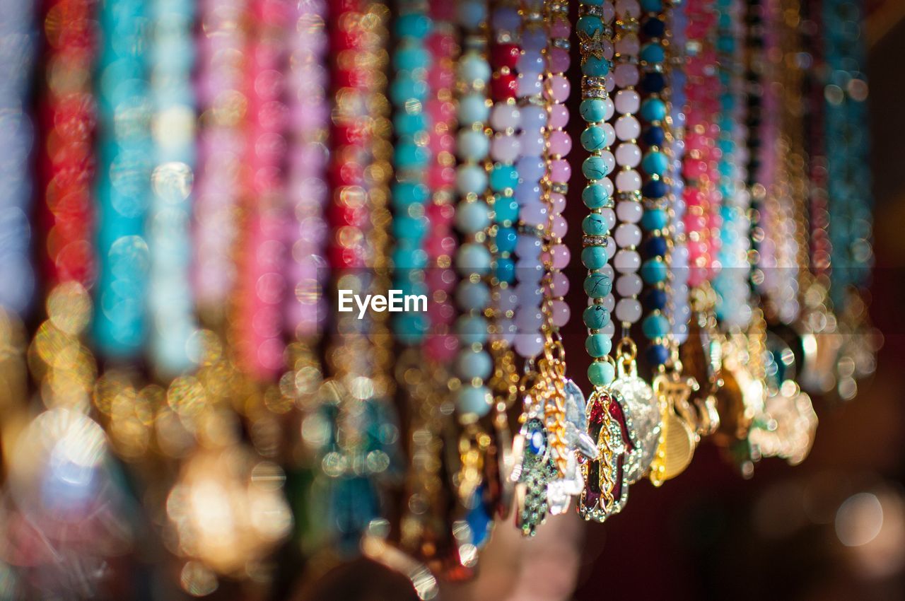 Colorful beads hanging at market for sale