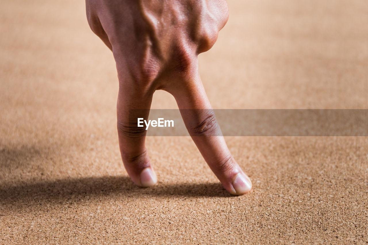 Close-up of hand on carpet