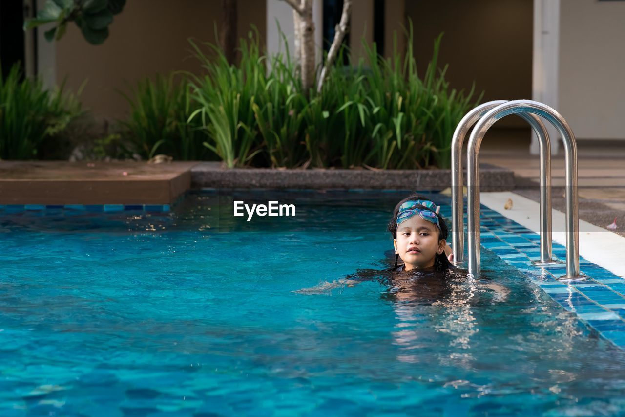 Portrait of boy swimming in pool