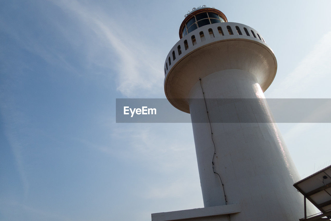 architecture, built structure, sky, building exterior, tower, lighthouse, low angle view, building, blue, nature, travel, security, protection, no people, day, travel destinations, cloud, outdoors, guidance, sunlight, observation tower, communication, technology, city