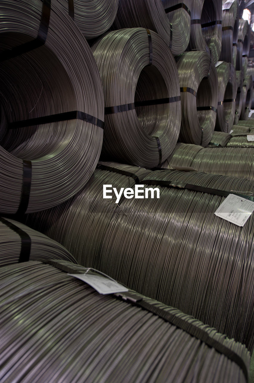 Full frame shot of metallic rolled up wires at steel plant