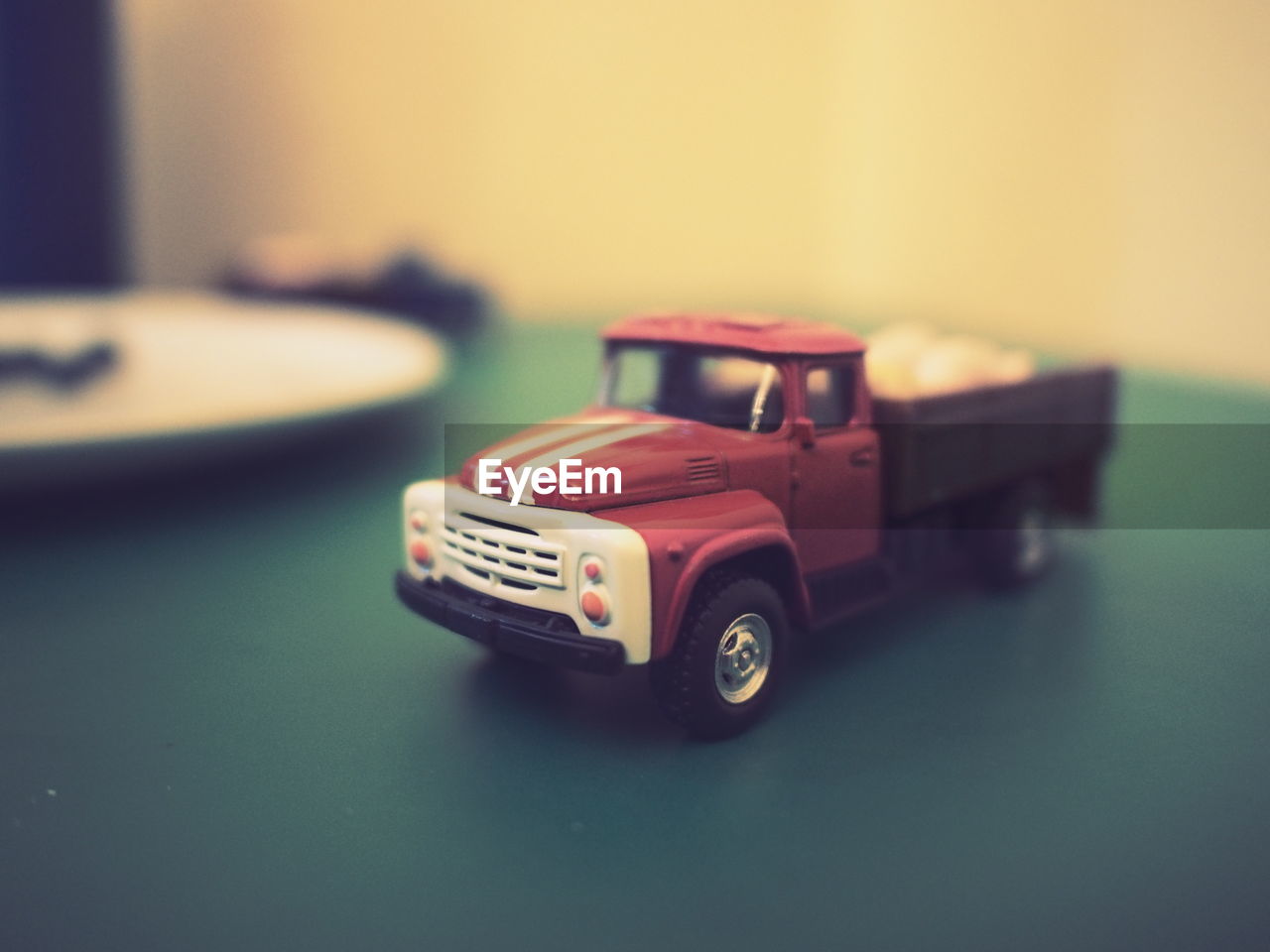 CLOSE-UP OF TOY CAR ON TABLE AT HOME