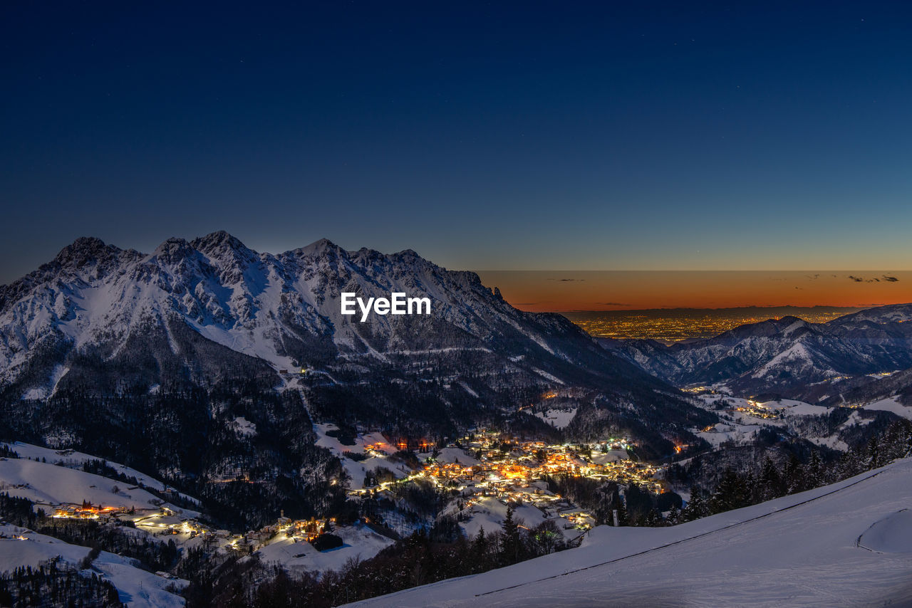 Snowy mountain village at sunset