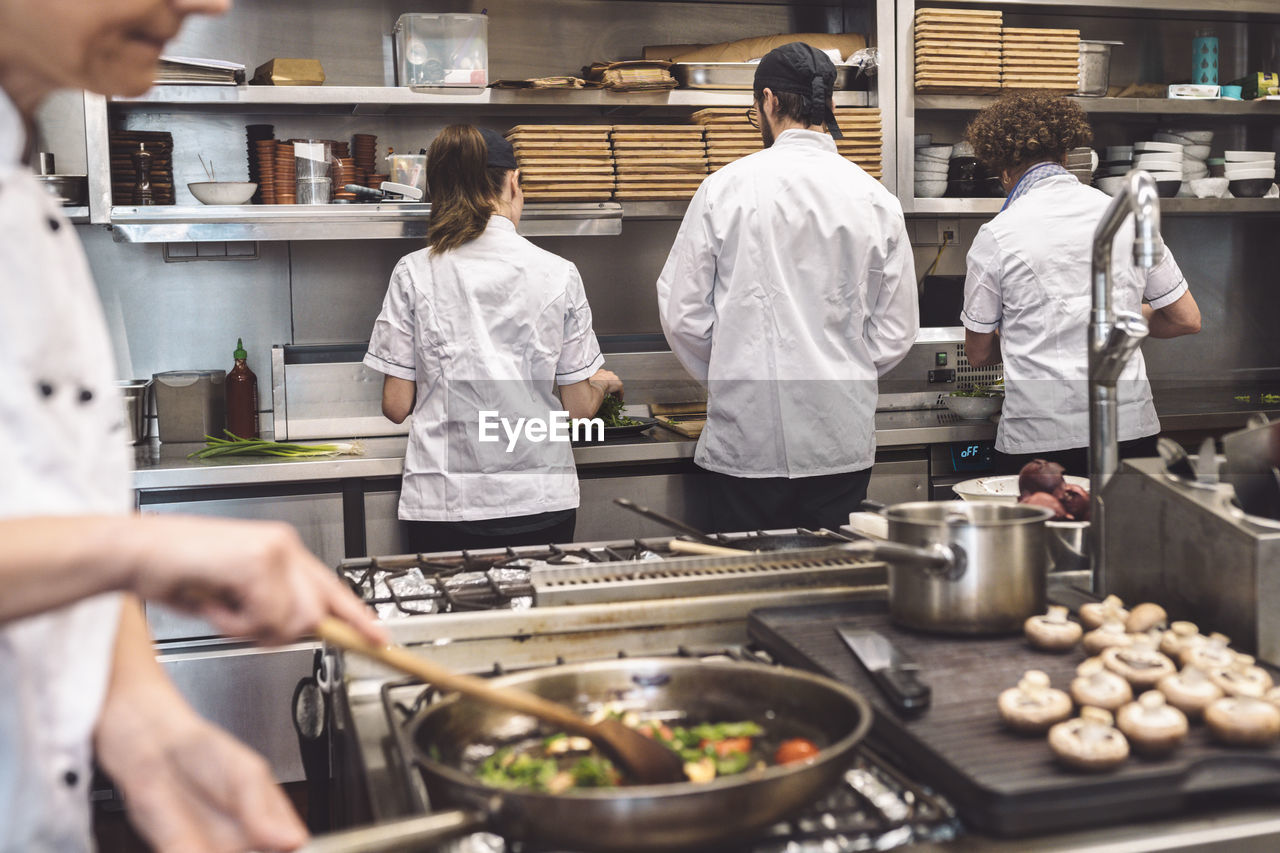 Midsection of chef preparing food in restaurant