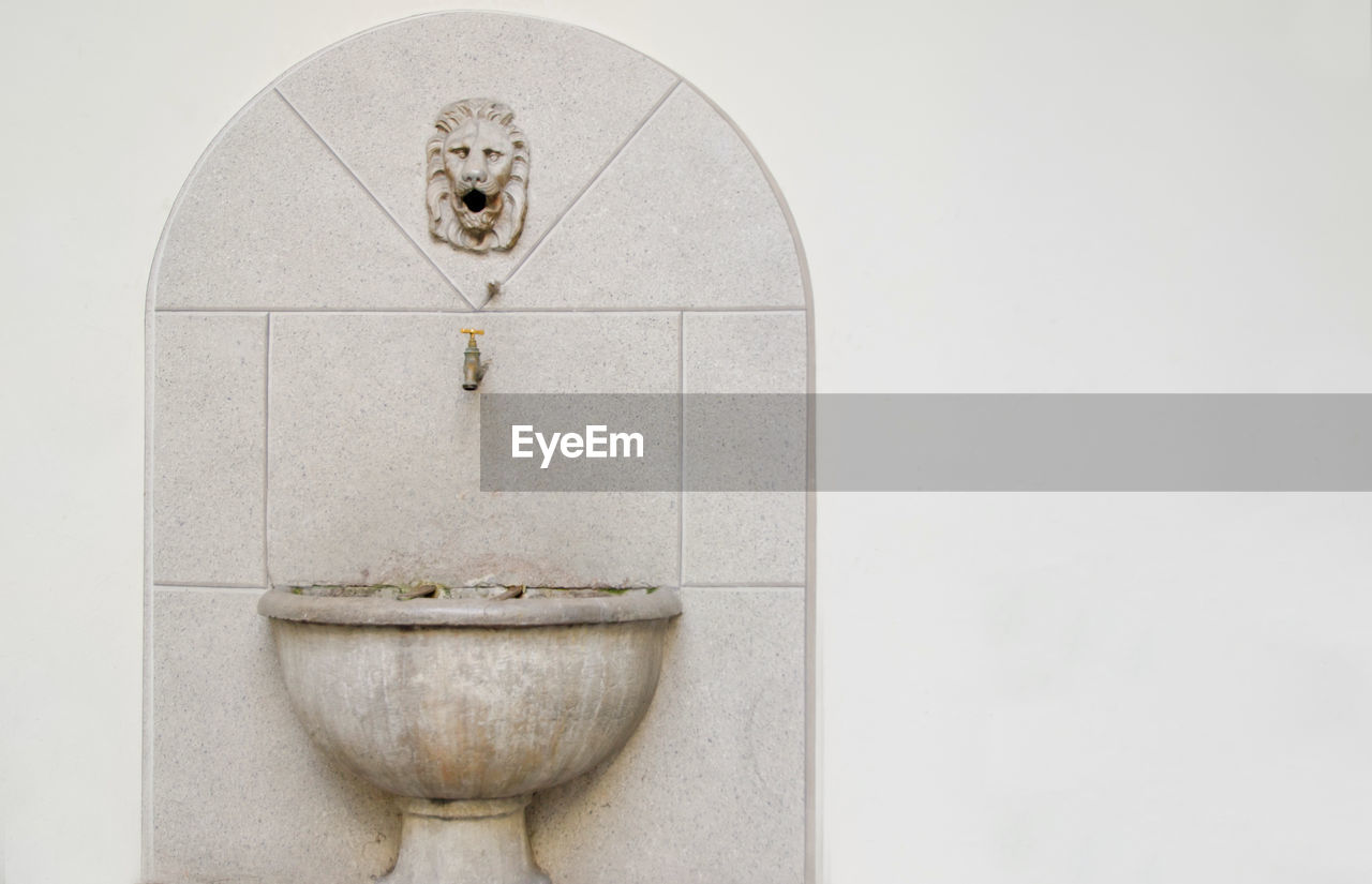 Faucet over sink on wall