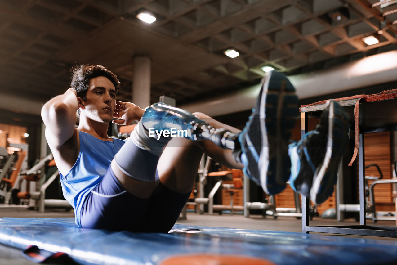 Man with artificial leg exercising in gym