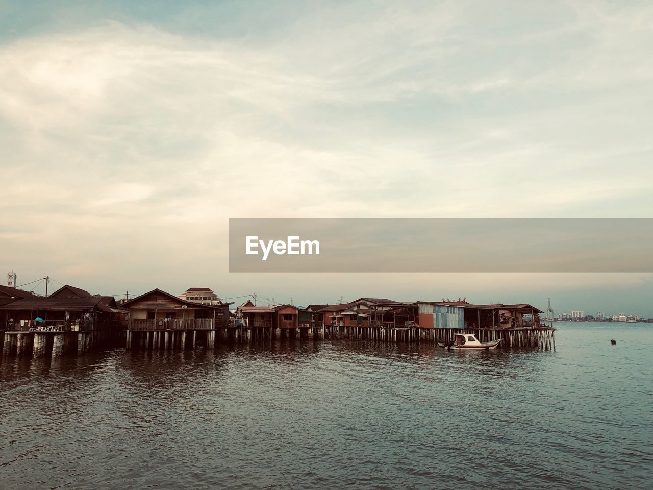 HOUSES BY SEA AGAINST SKY AND BUILDINGS