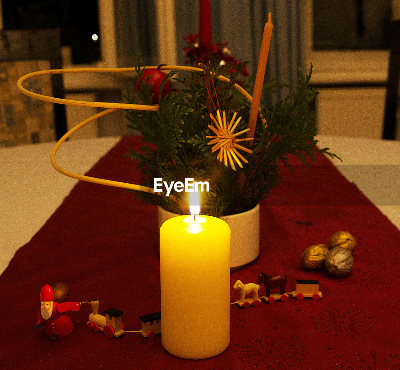candle, burning, fire, flame, christmas, holiday, decoration, celebration, nature, yellow, illuminated, christmas decoration, lighting, indoors, interior design, heat, no people, centrepiece, religion, tradition, table, candle holder, plant, flower, spirituality, candlestick holder, event, belief, christmas ornament, glowing, red, wreath, christmas tree