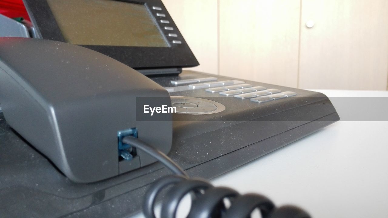 Close-up of conference phone on table in office