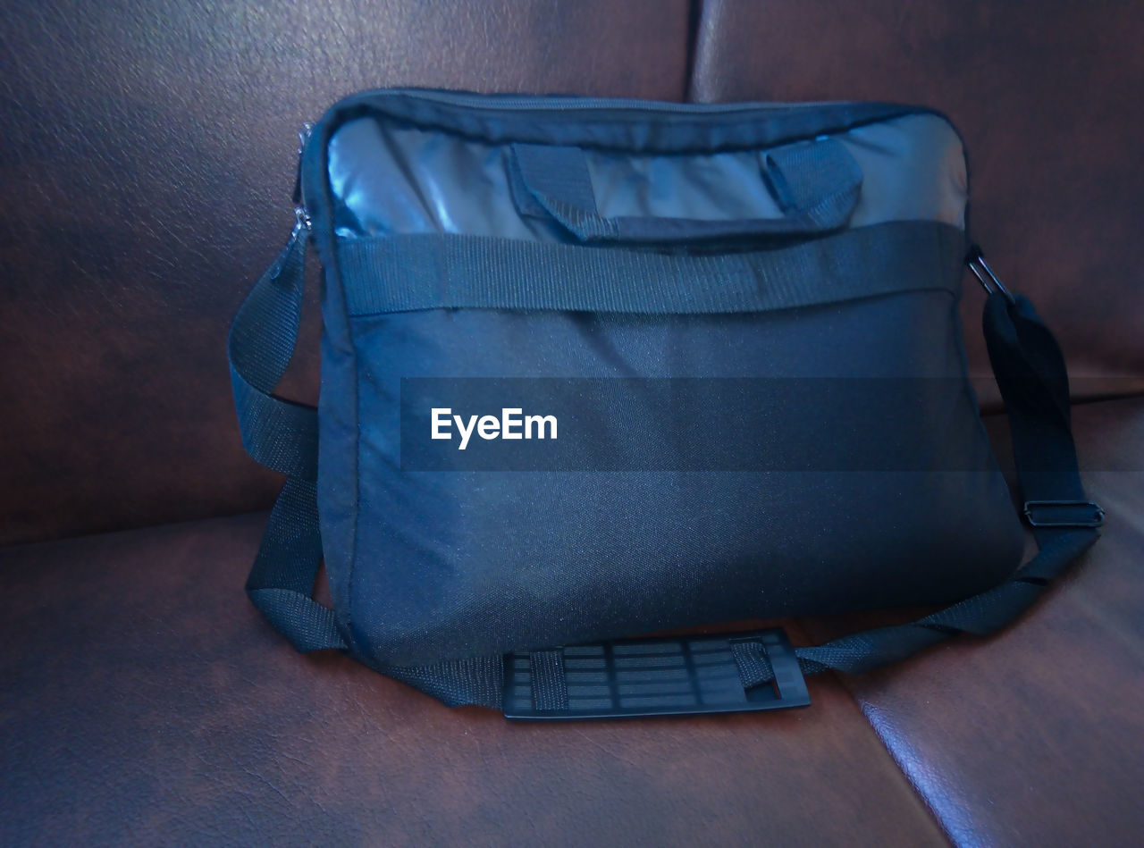 High angle view of messenger bag on sofa at home