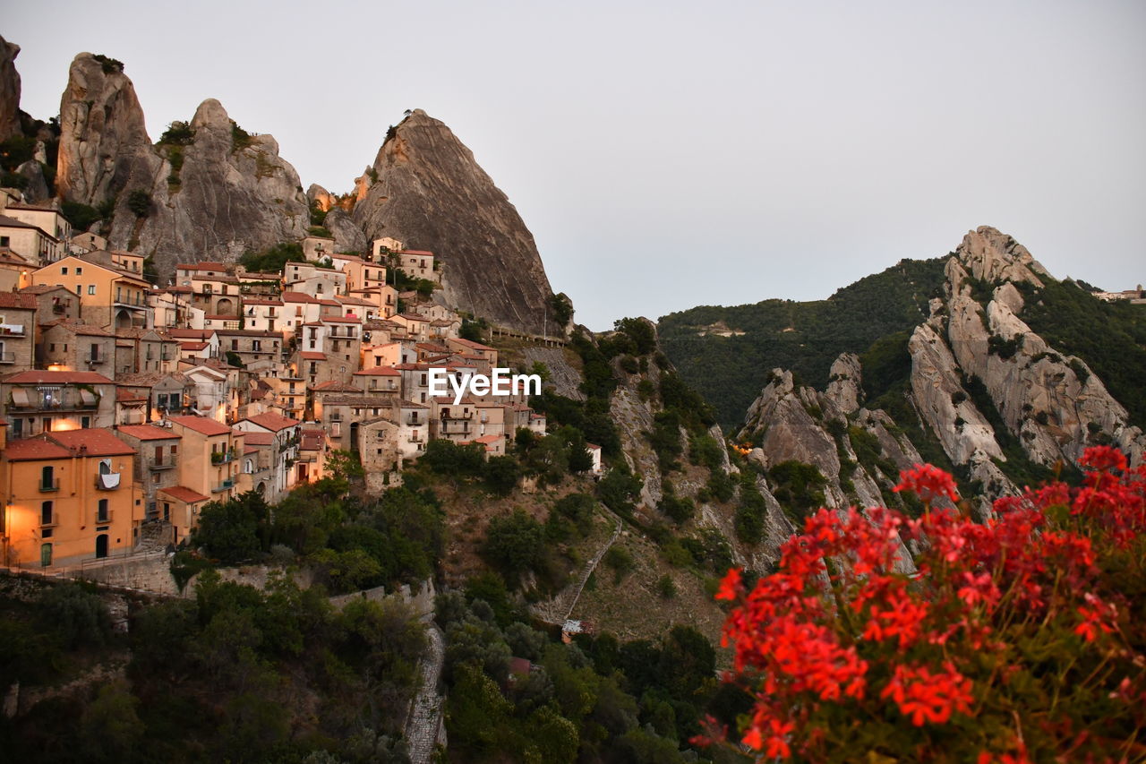 High angle view of townscape and mountains against clear sky