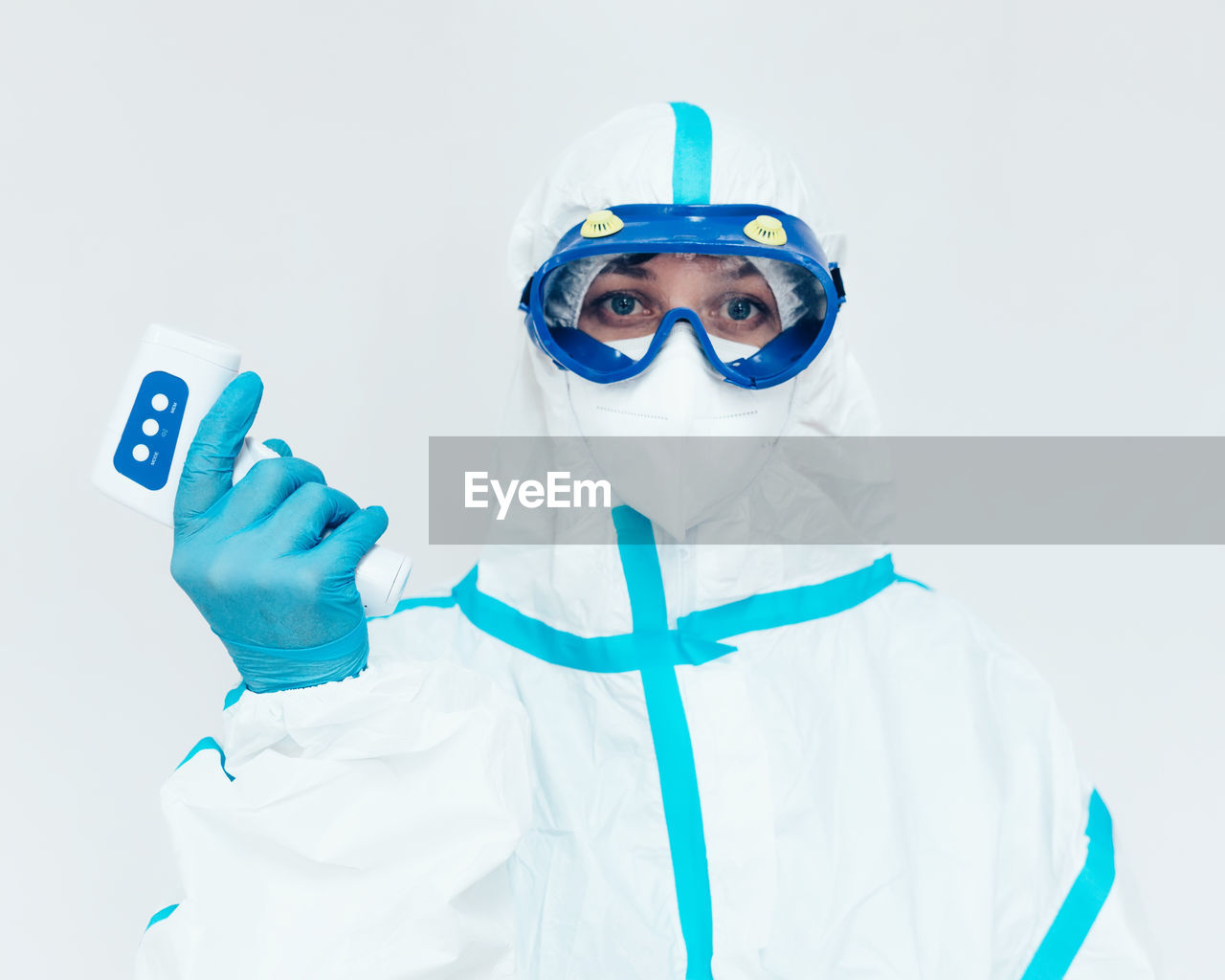 Portrait of man wearing mask against white background