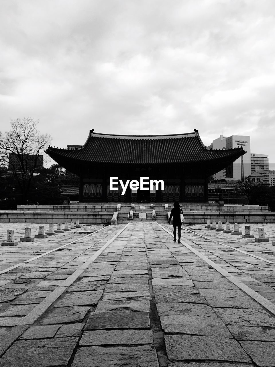 Silhouette man walking against built structure