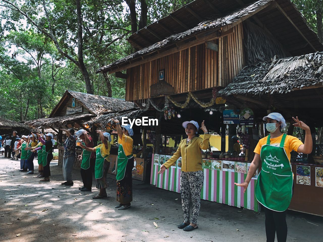 GROUP OF PEOPLE STANDING BY TREE