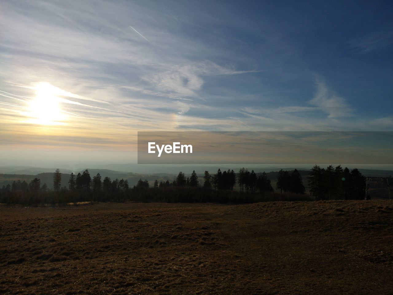 Scenic view of field against sky during sunset