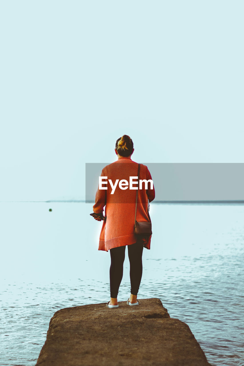 rear view of man standing on beach