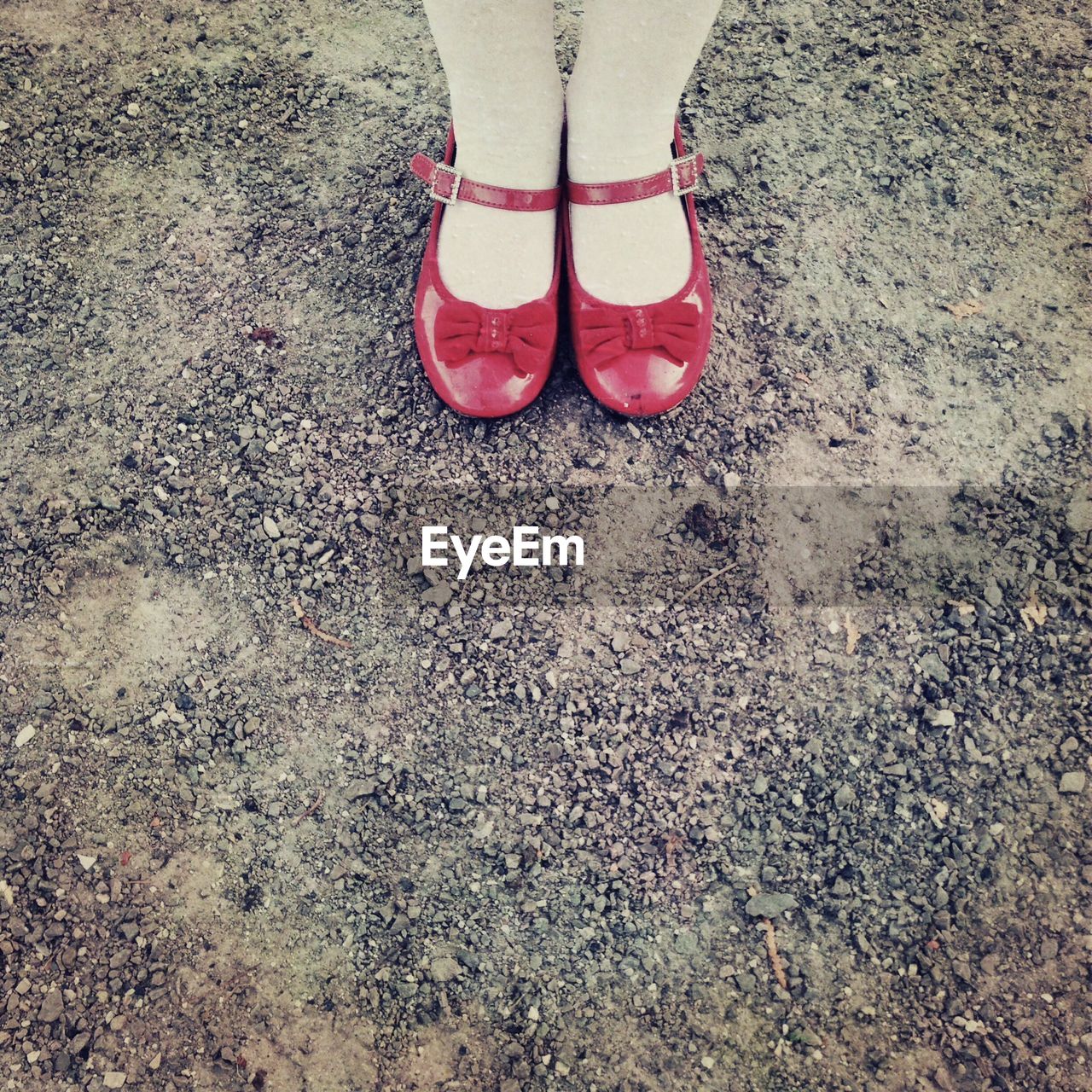 Low section of woman wearing red shoes outdoors