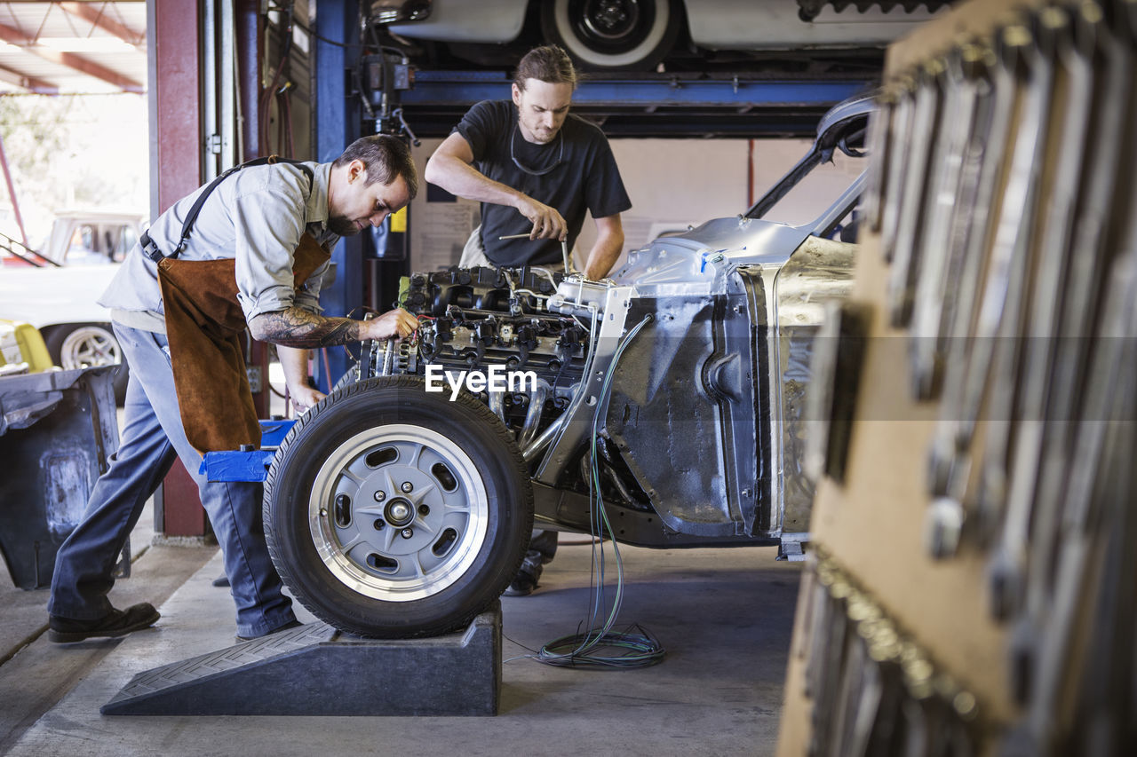 Mechanics repairing car at auto repair shop