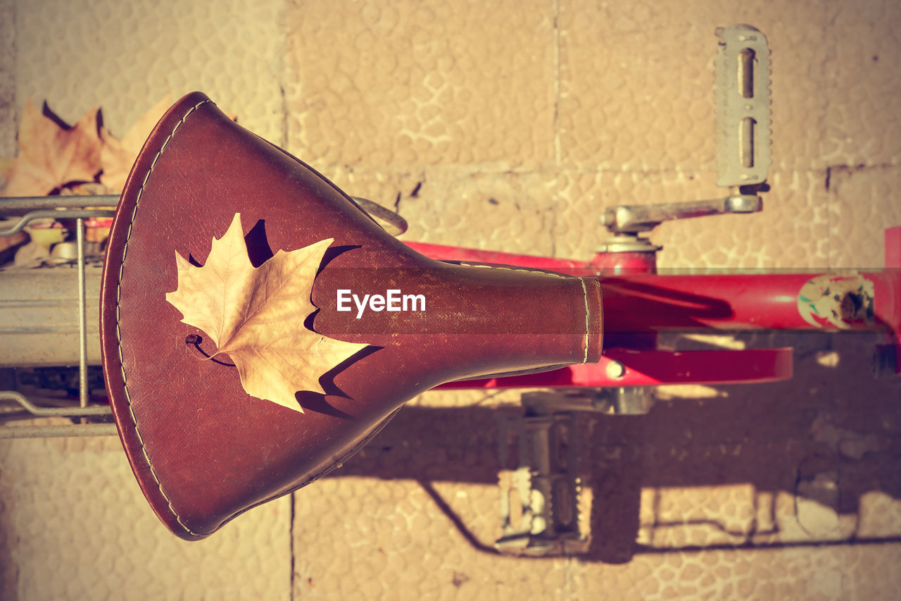 CLOSE-UP OF BICYCLE AGAINST WALL