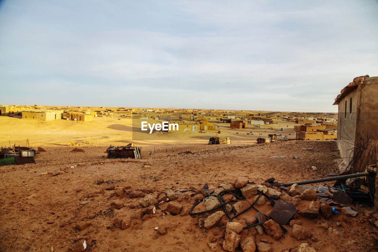 Houses at desert against sky