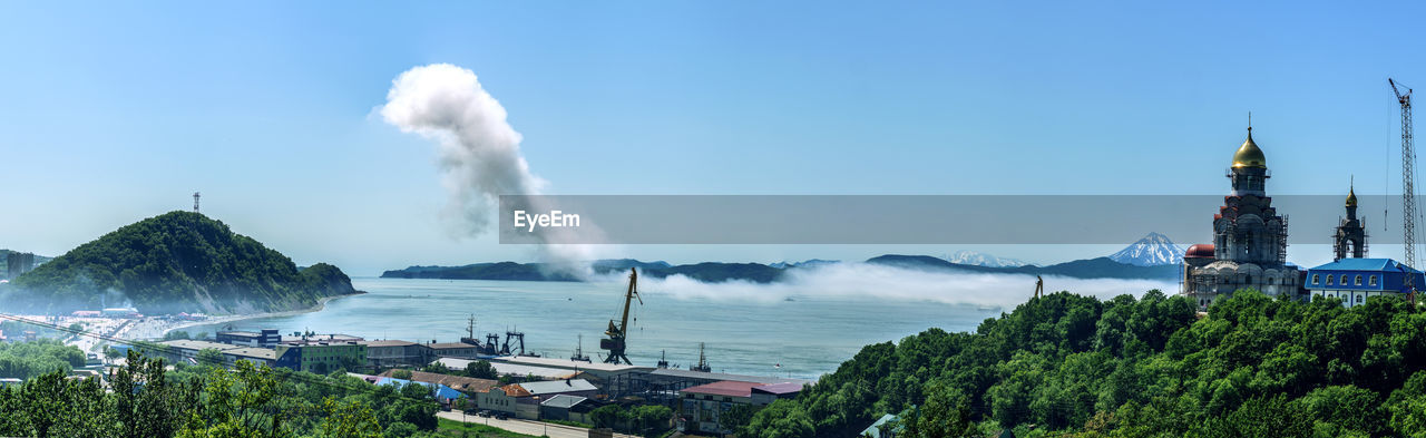 Panoramic view of buildings and sea against sky