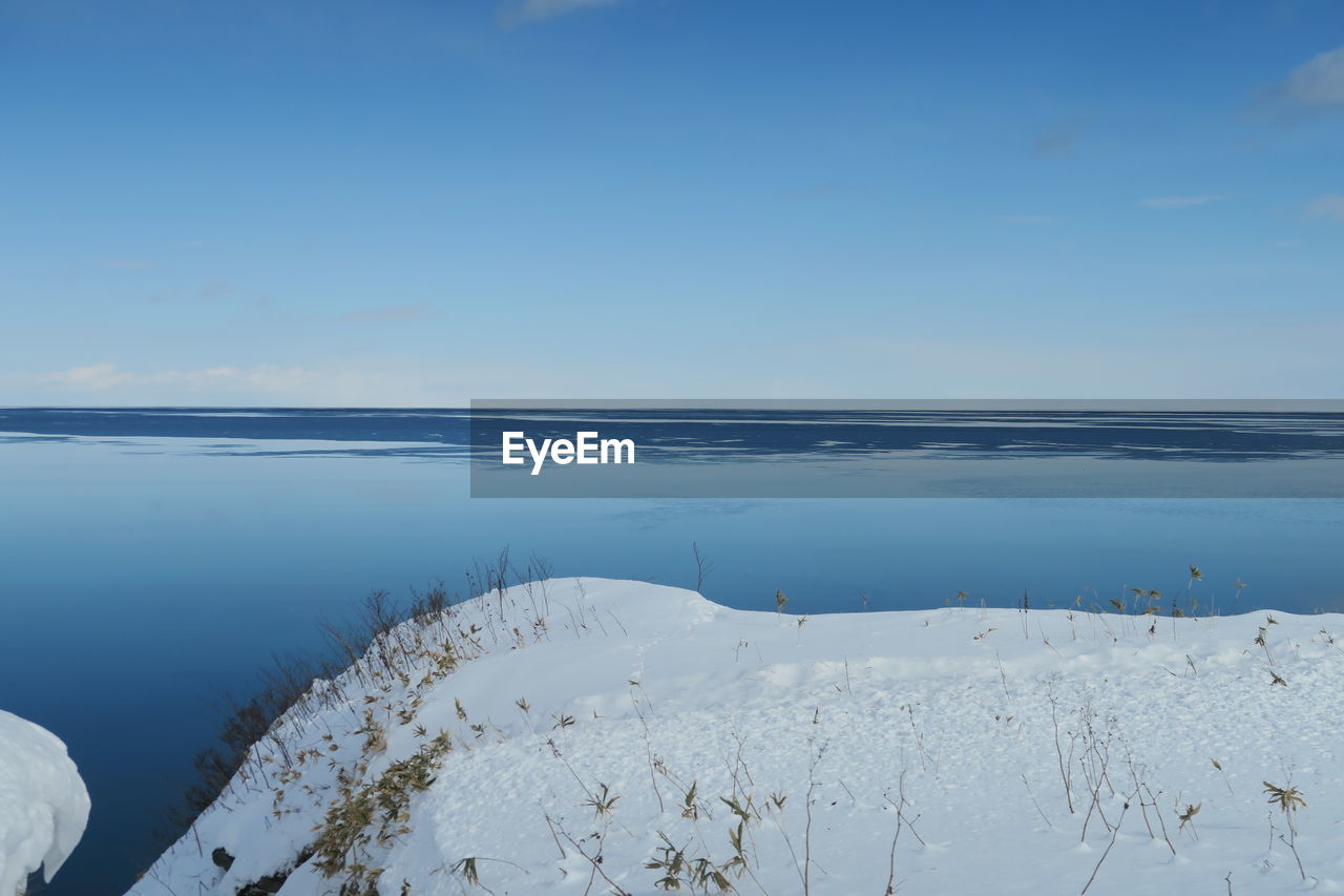 Scenic view of sea against sky during winter