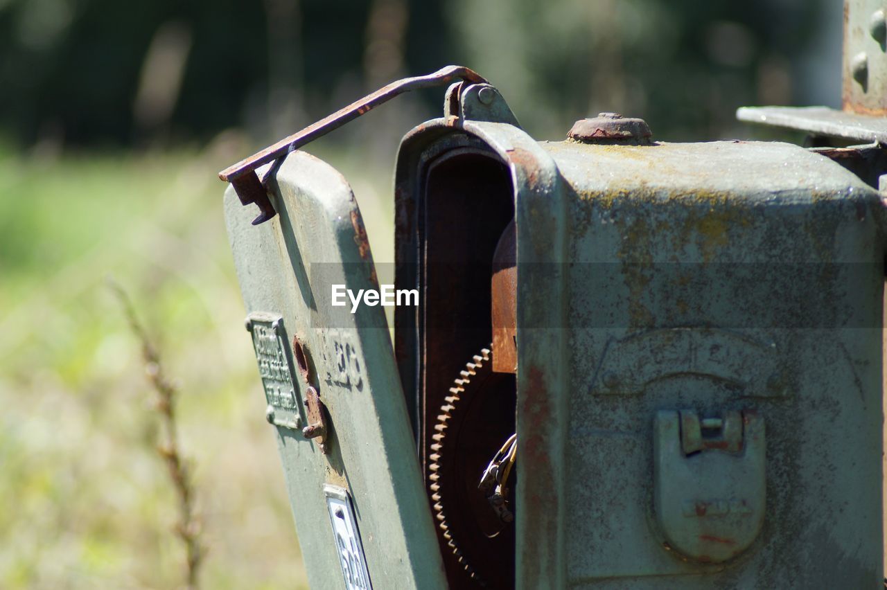 CLOSE-UP OF OLD RUSTY MACHINE PART