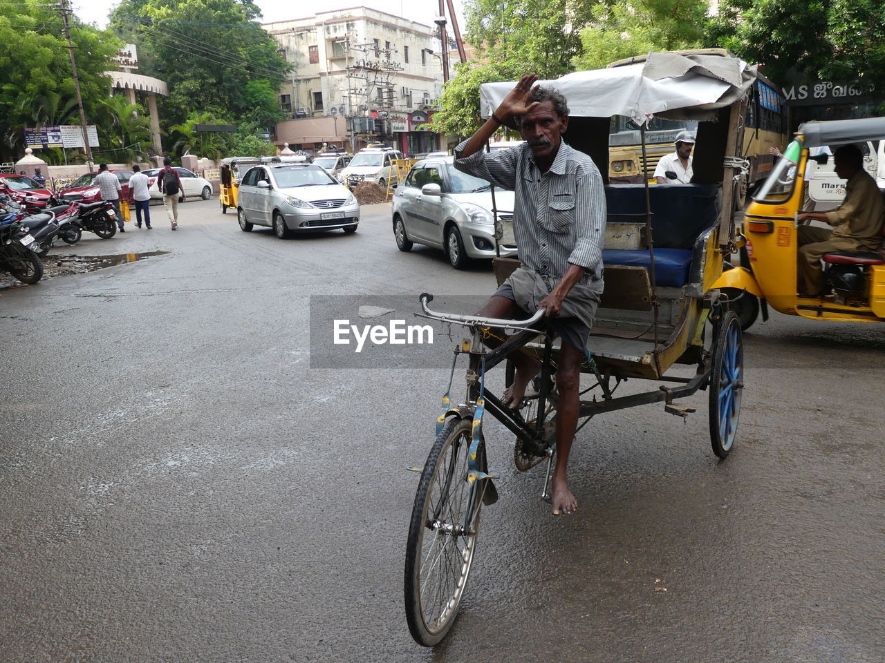 MAN RIDING BICYCLE ON STREET IN CITY