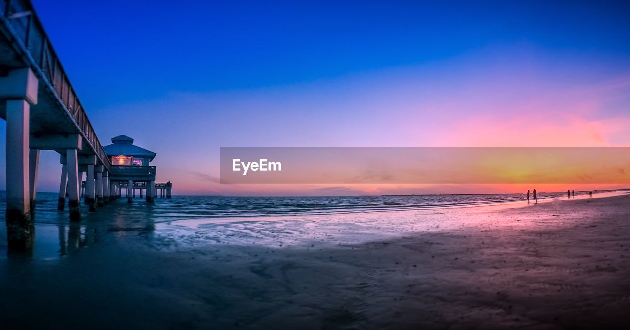 Pier at fort myers beach against sky at sunset