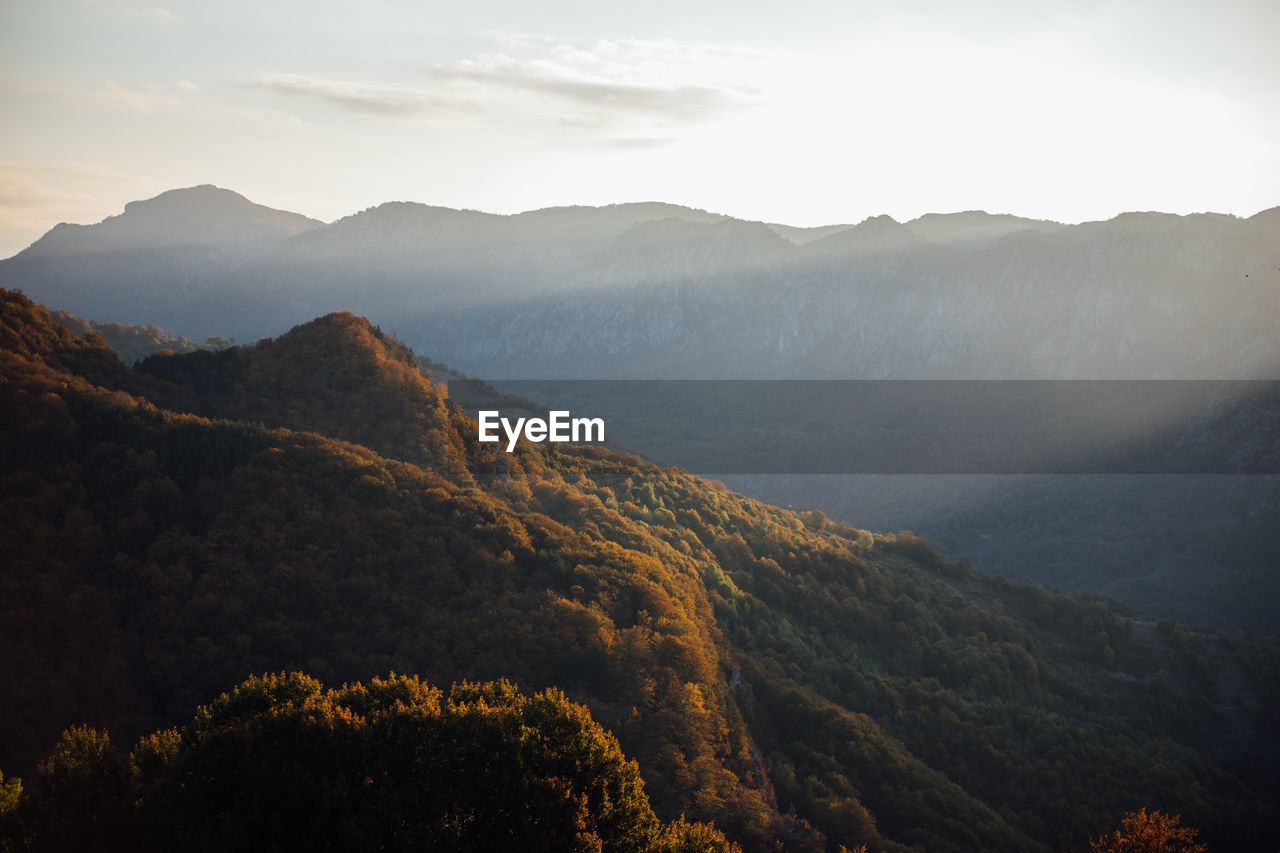 Scenic view of mountains against sky at sunset. captured from above with drone