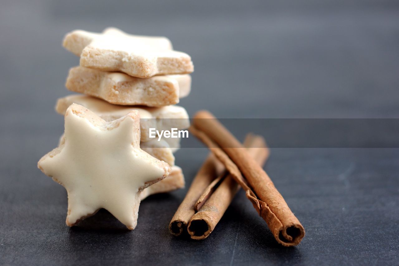 Close-up of star shaped cookies with cinnamons on table