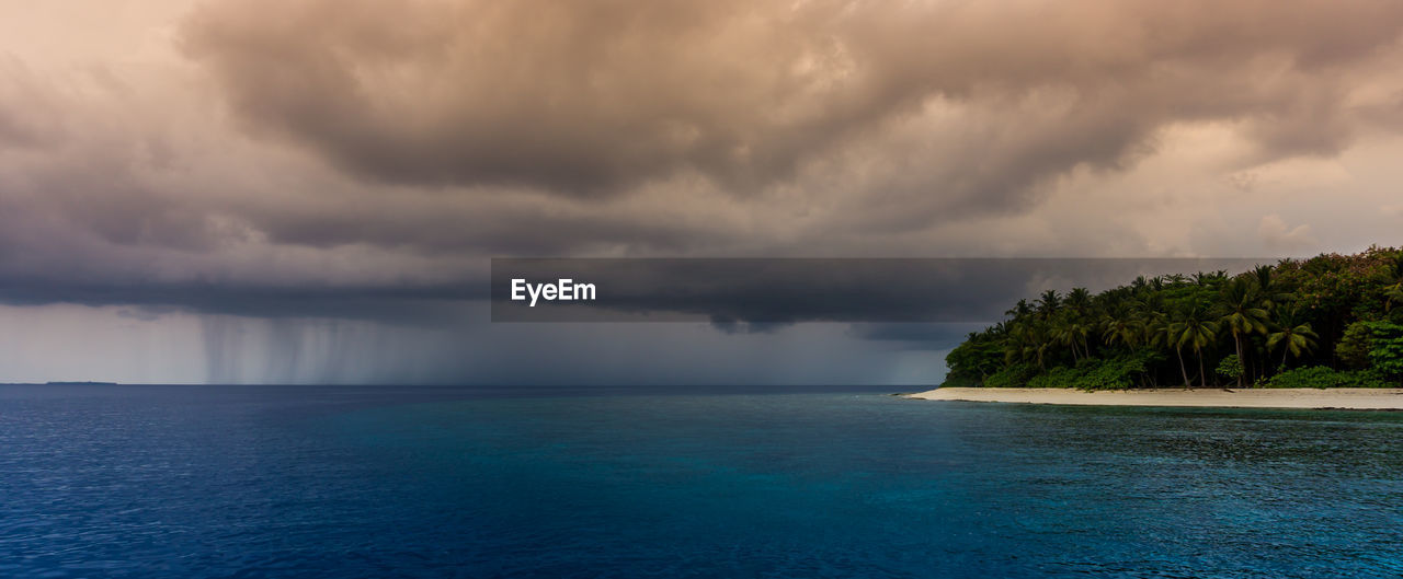 Scenic view of sea against storm clouds