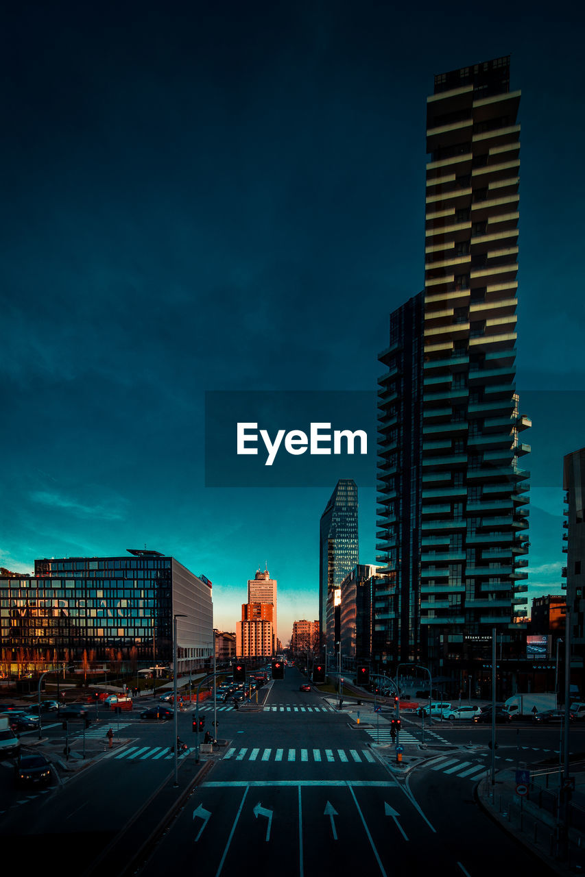 City street by buildings against sky at dusk milan italy 