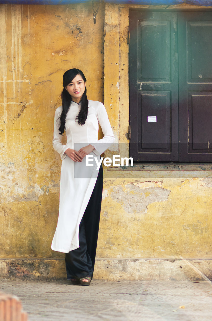 Young vietnamese girl wearing ao dai dress.