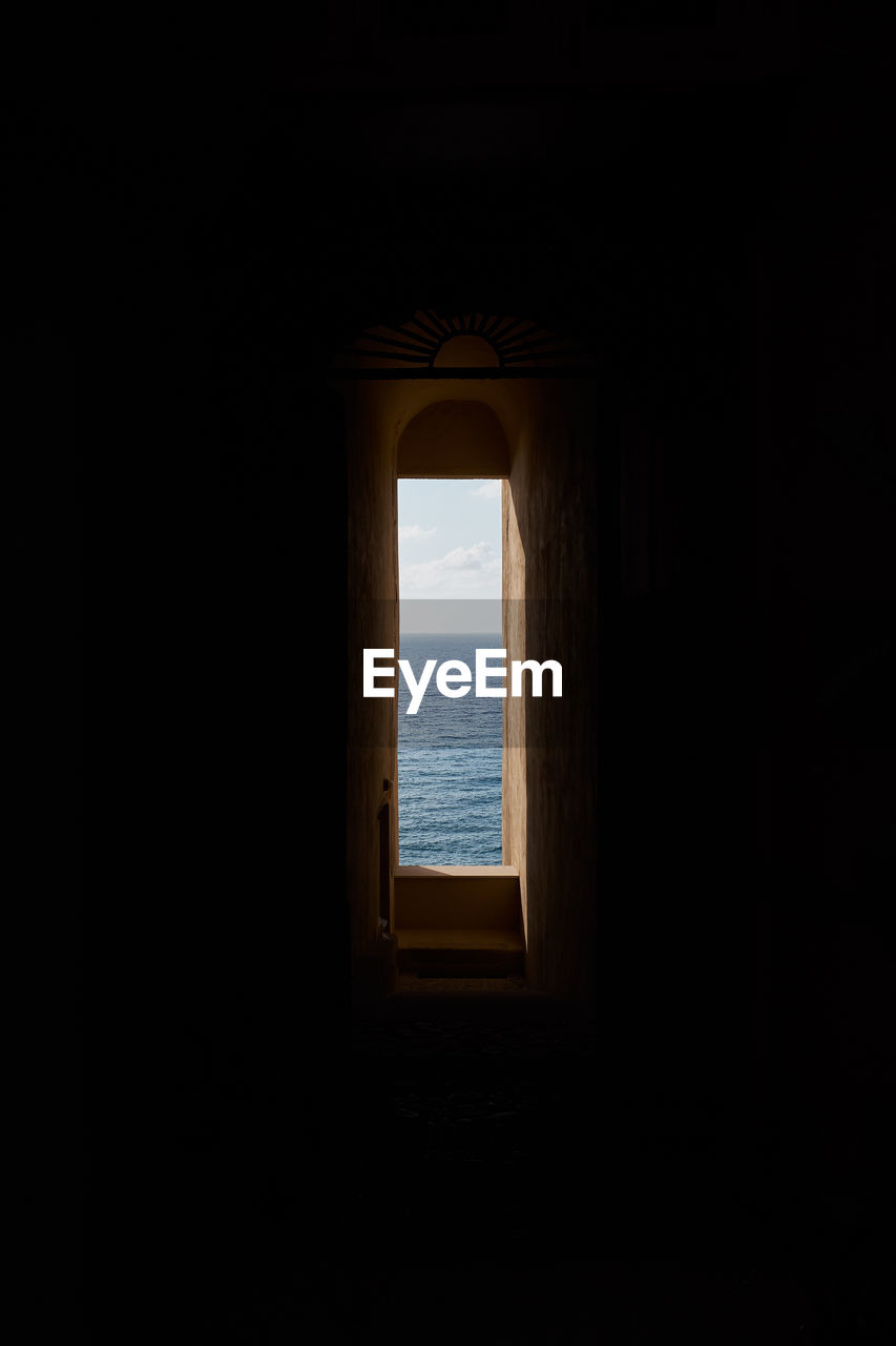 WINDOW IN SEA AGAINST SKY SEEN THROUGH ARCH