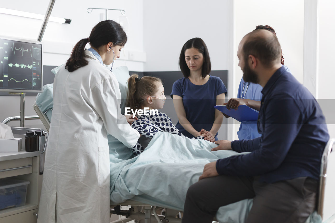 Doctor and nurse examining patient at hospital