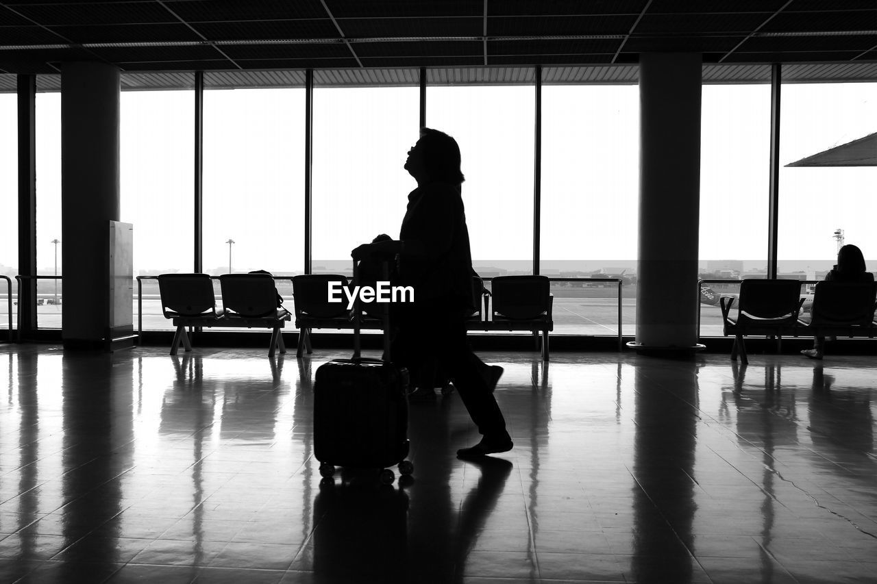 SILHOUETTE PEOPLE ON AIRPORT