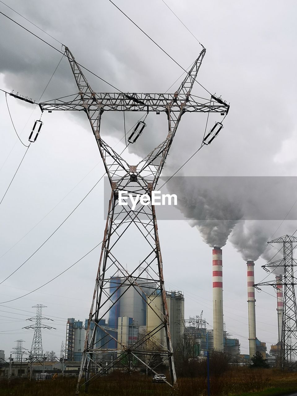 Low angle view of smoke emitting from chimney against sky