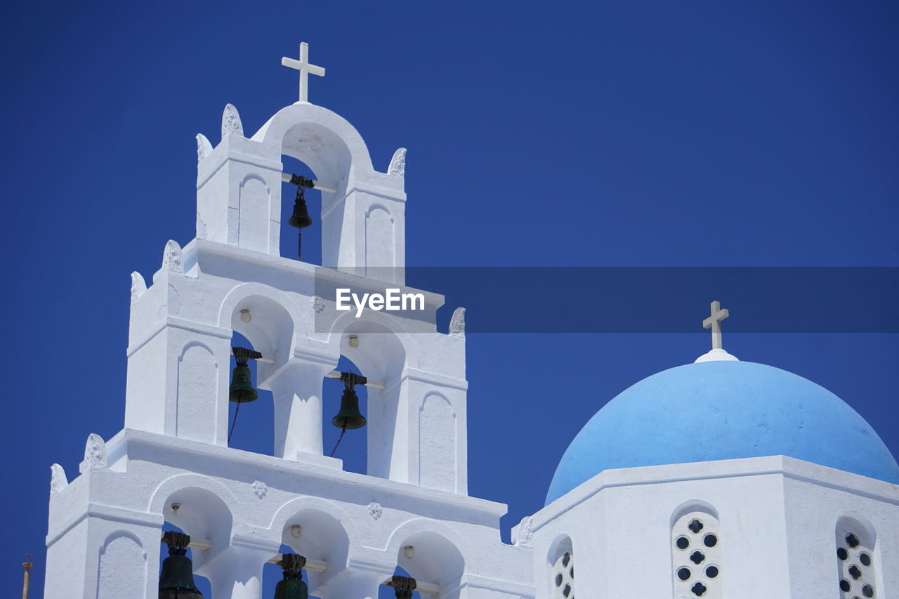 Low angle view of white building against blue sky