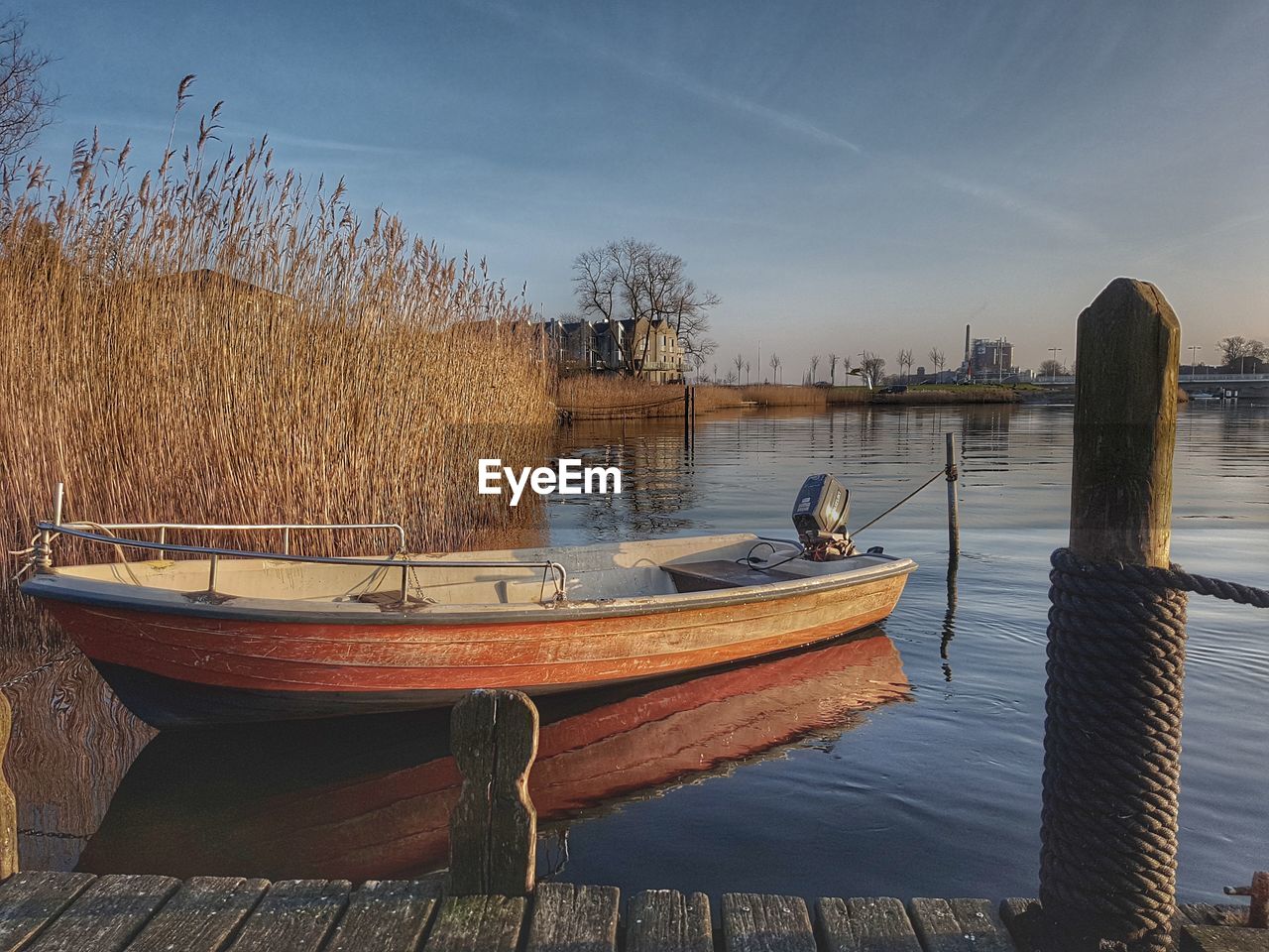 Boats moored on lake against sky