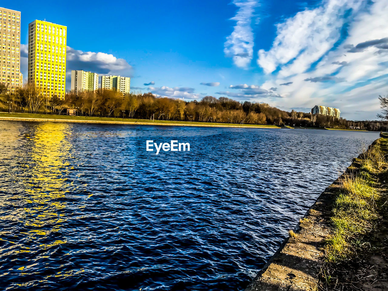 SCENIC VIEW OF LAKE AGAINST BUILDINGS IN CITY