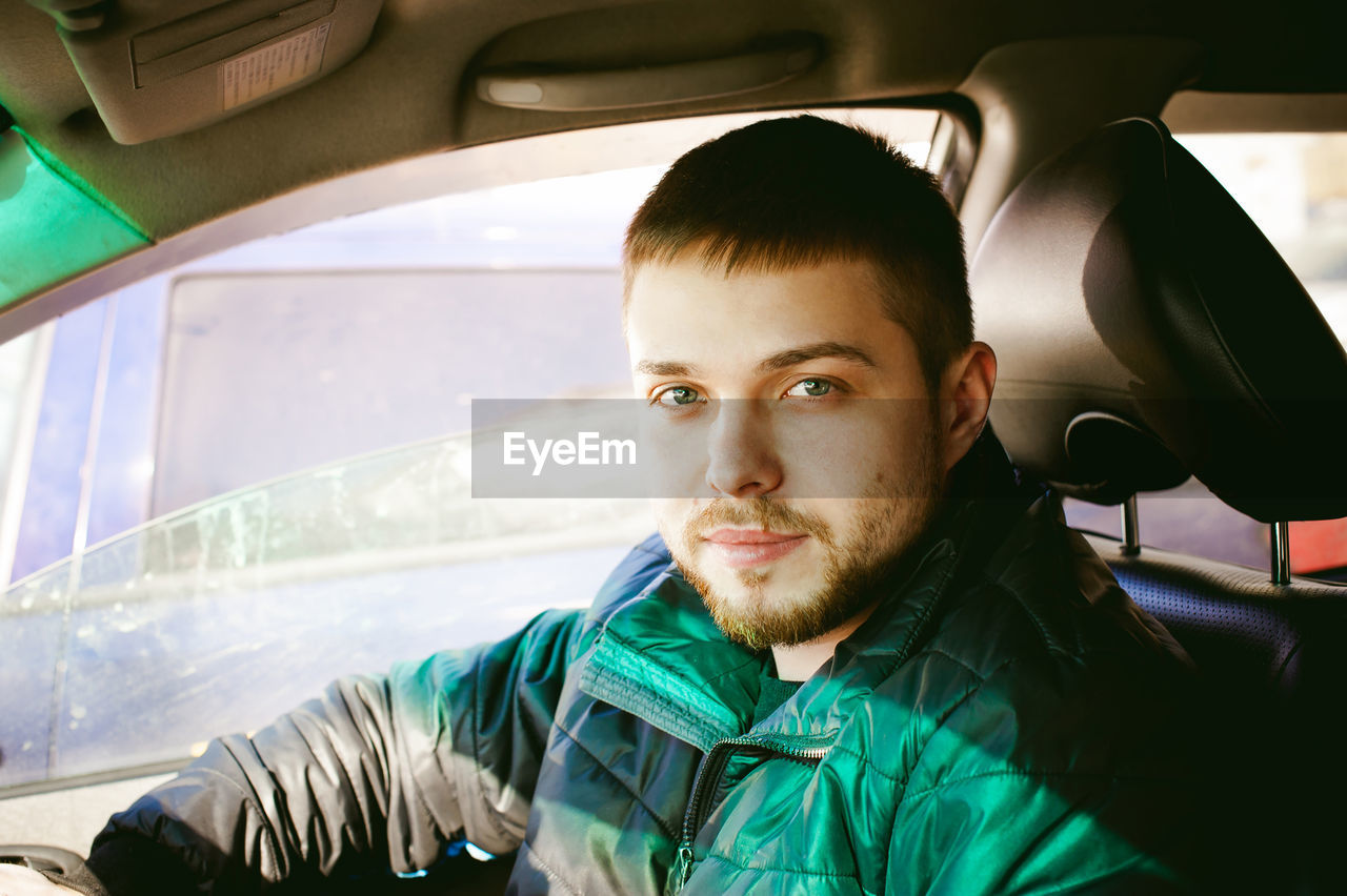 Portrait of man sitting in car