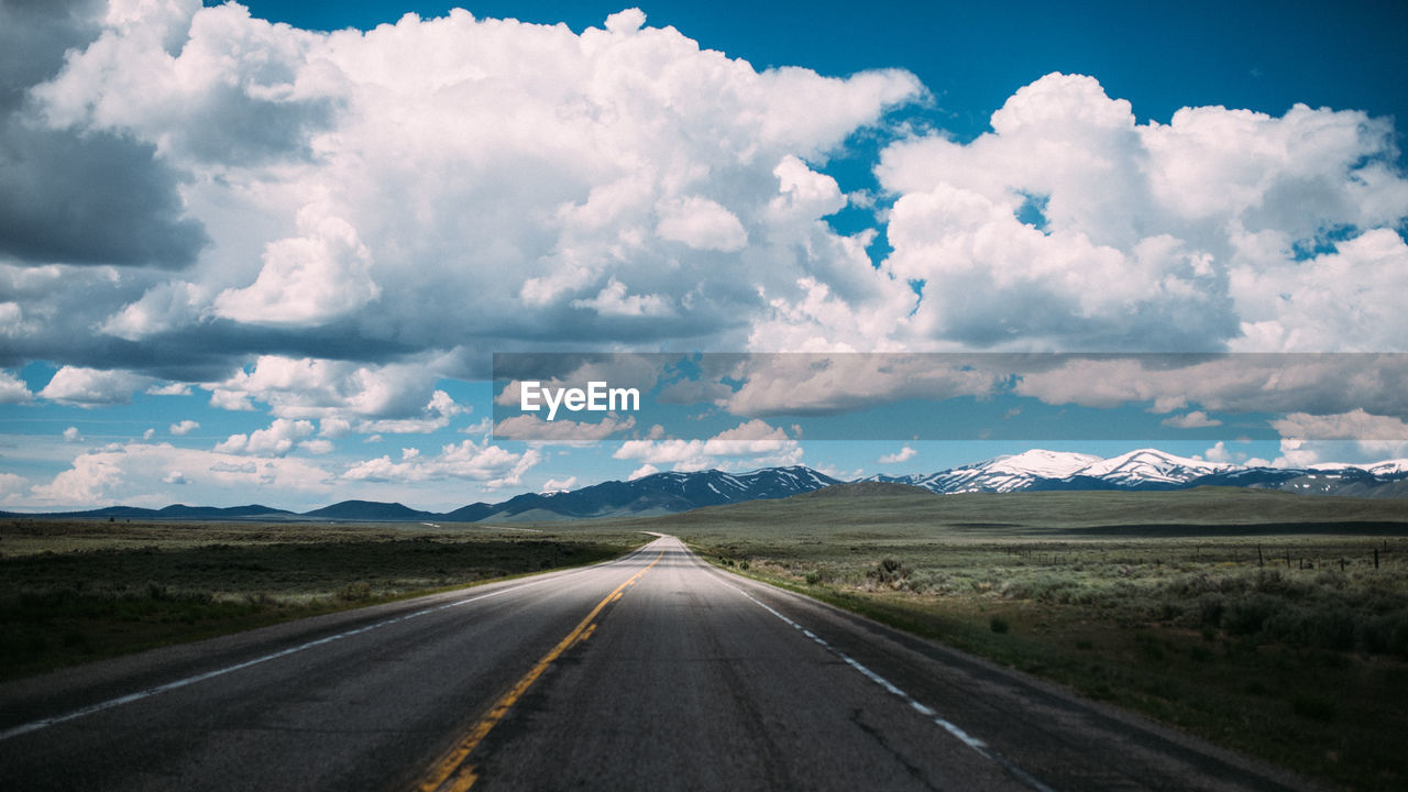 Road amidst landscape against sky