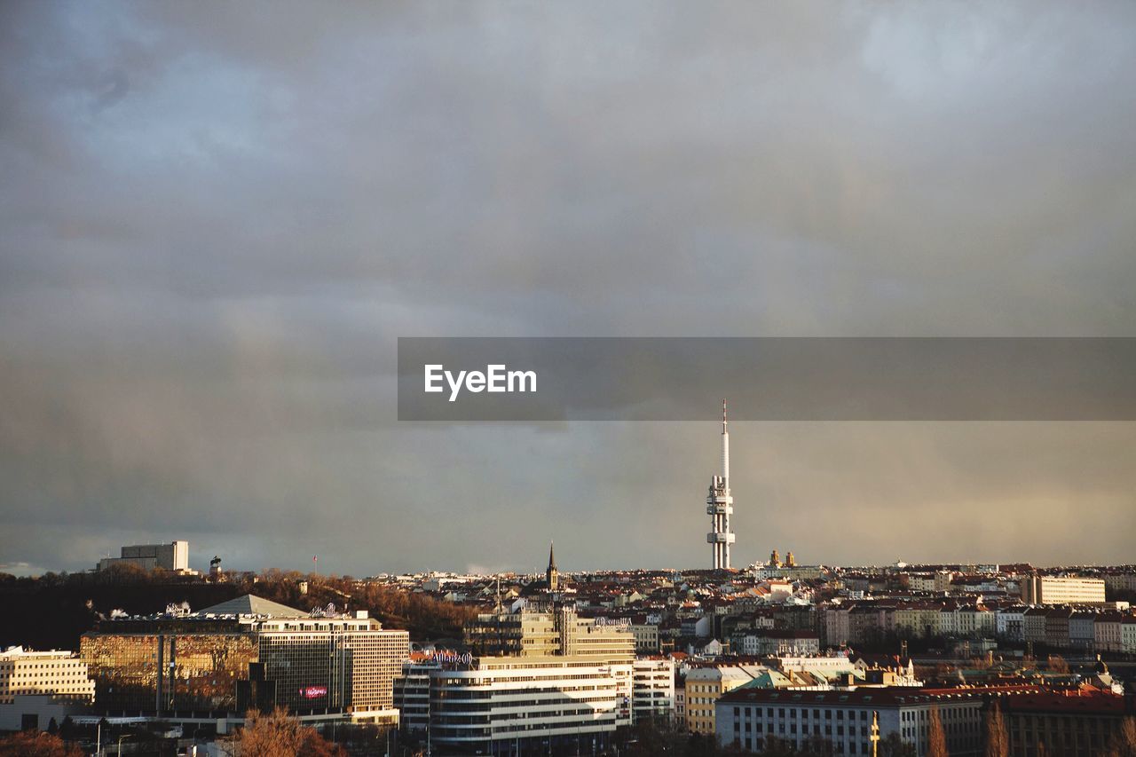 High angle shot of cityscape against clouds