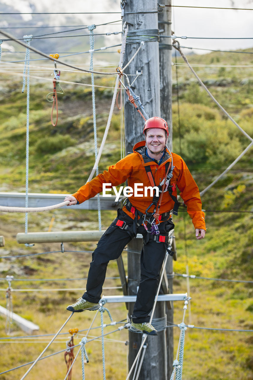 Man balancing on high rope obstacle course in iceland