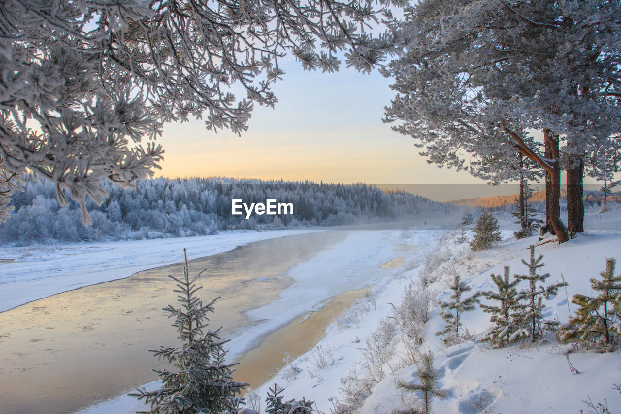 Scenic view of snow covered land against sky