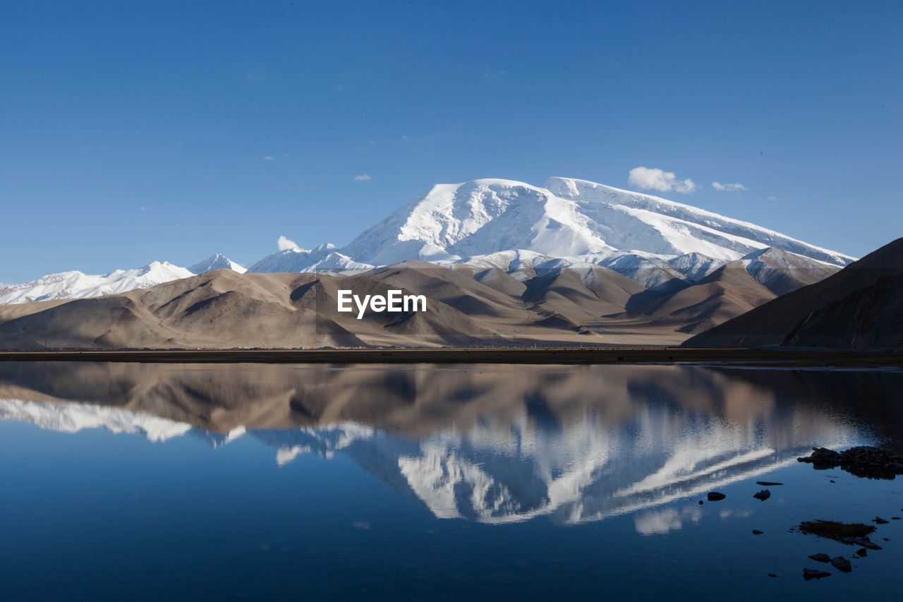 Scenic view of frozen lake against mountain range